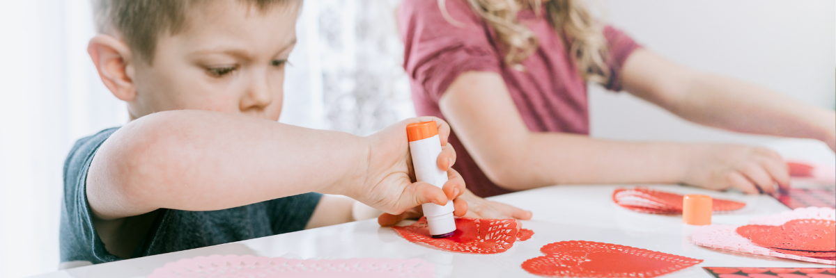Kids creating valentine's post cards for valentines day activities.
