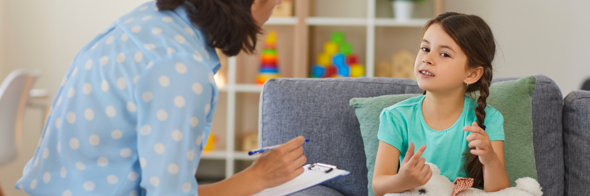 Anxious during therapy session, a kid is seated with a therapist.