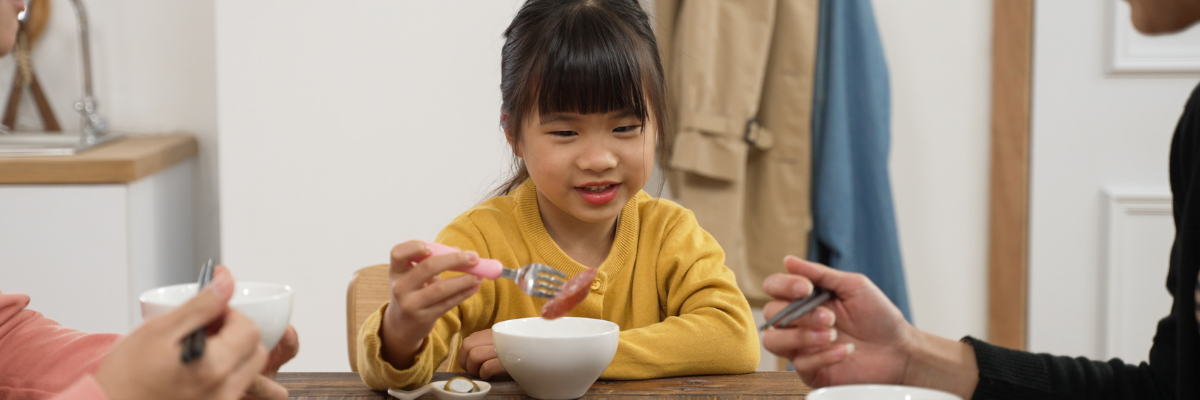Child exploring different foods during a mealtime activity